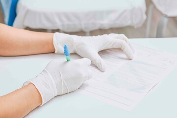 Fototapeta premium healthcare professional carefully filling out paperwork underscores necessary in medical environments