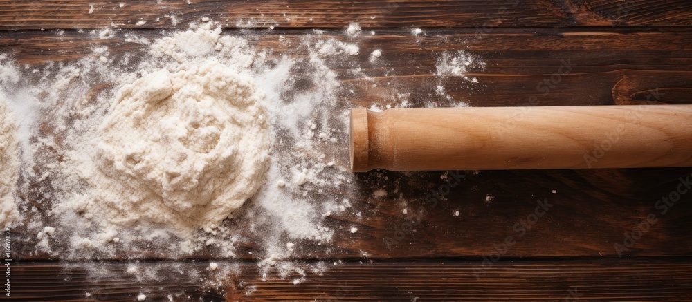 Aufkleber top-down view of a rolling pin on a wooden table, dusted with flour, in a copy space image.