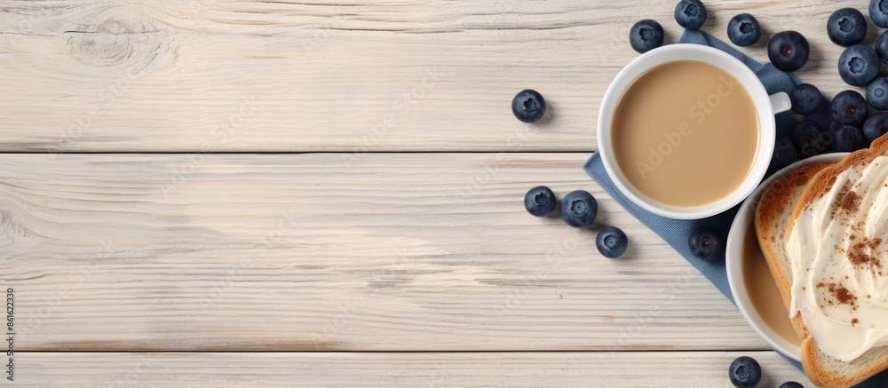 Fototapete Tasty toasts with butter, blueberries, and coffee displayed on a gray wooden surface in a flat lay style. Ideal for adding any text in the image. with copy space image
