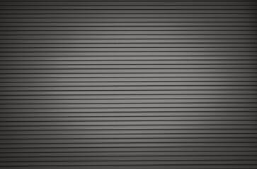 Obraz premium A black and white photo of a wall with a lot of vertical lines