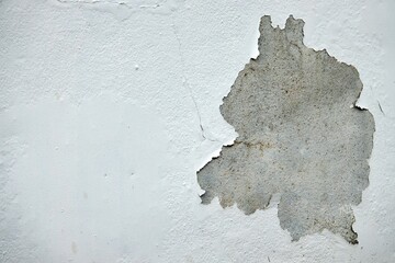 A white wall with a crack in it