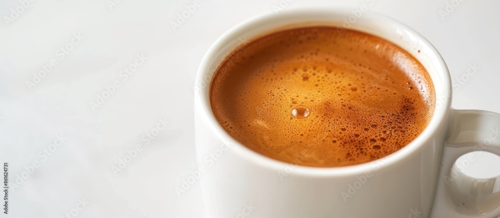 Poster close up of a cup with espresso cream, showing a beautiful texture, placed on a white table with an 