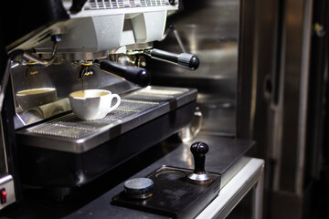 Making A Shot of Espresso from Espresso Coffee Machine with Steam from the machine