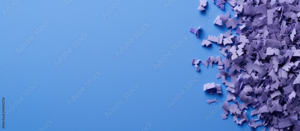 Poster close-up view of a blue pencil, shavings, crumbs, and sharpener arranged on a violet background with