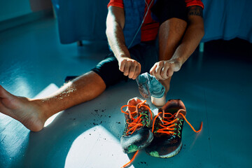 Man taking off dirty shoes at home after workout