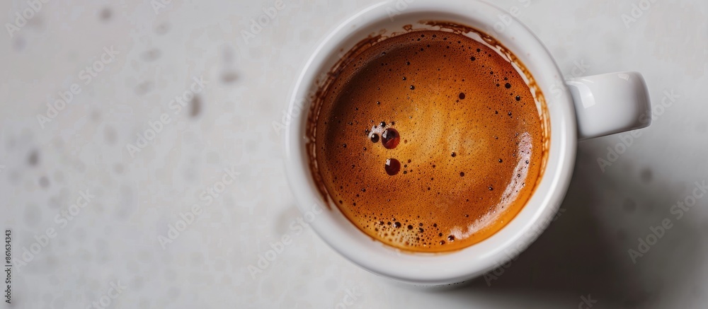 Poster Close up of a cup with espresso cream, showing a beautiful texture, placed on a white table with an aromatic medium-dark Arabica coffee copy space image.