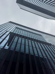 Fototapeta premium Commercial modern city. Bottom up view glass buildings skyscrapers. business concept