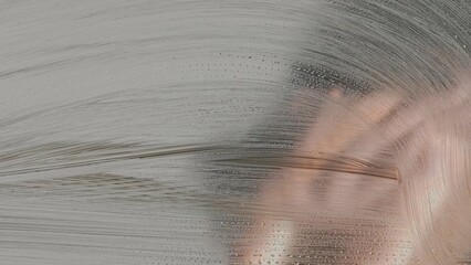 Abstract streaks and droplets on glass surface
