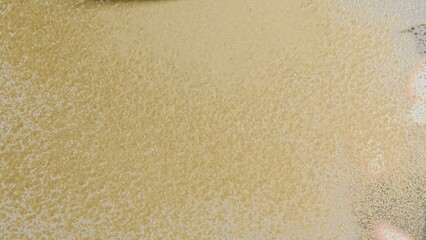 Textured gold paint on glass surface