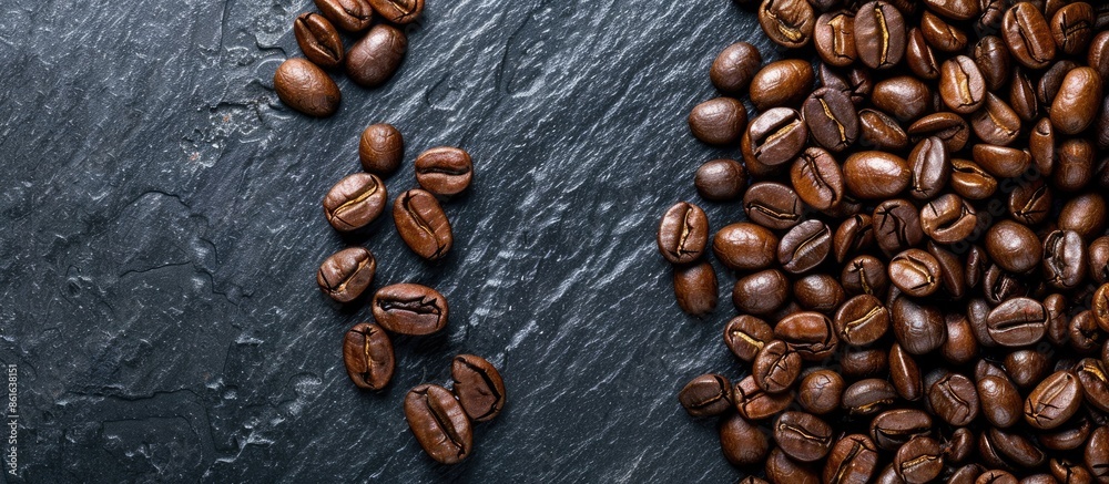Aufkleber Coffee beans arranged on a textured black slate background with copy space image.