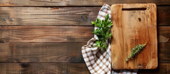 Wooden cutting board and a kitchen towel arranged in a flat lay with a space for adding text or images. with copy space image. Place for adding text or design