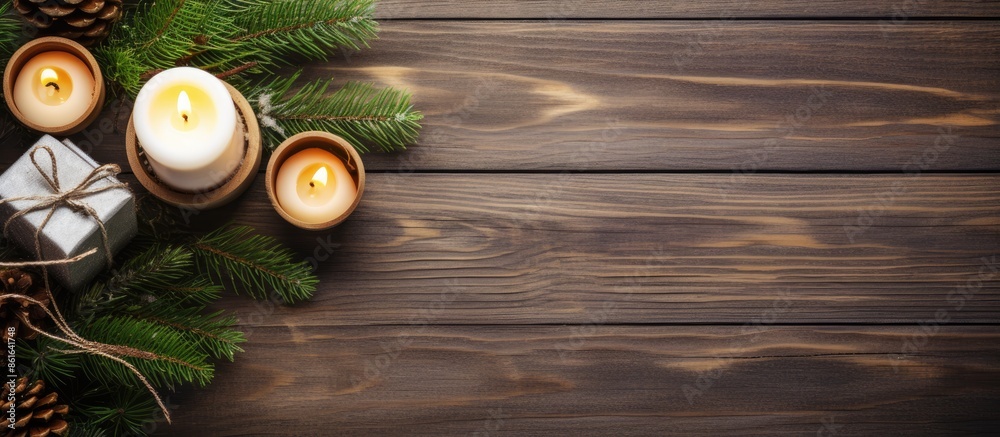 Poster top view of a festive christmas table arrangement featuring candles, a gift box, and a snowy fir tre