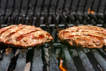 Homemade burger patty on a gas grill.  Ready to eat.