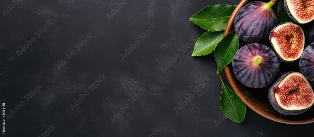 Aufkleber top view of fresh figs in a wooden bowl on a stone table with a dark background, ideal for copy spac