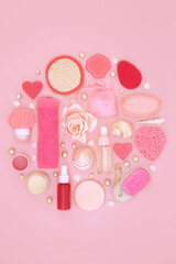 Natural skincare anti wrinkle beauty treatment products. Natural feminine spa and bath accessories for healthy skin on pink background. Abstract circle design.