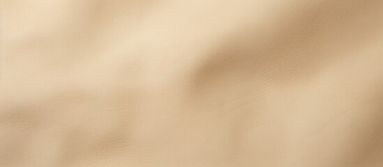 Obraz premium Close-up view of a light beige matte suede background showcasing a seamless sand leather texture, ideal for a copy space image.