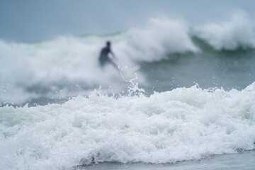 Surfer in the Mist of Ocean Waves