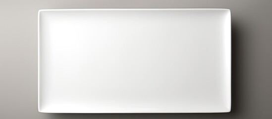 Rectangular white ceramic plate on a white backdrop with copy space image.