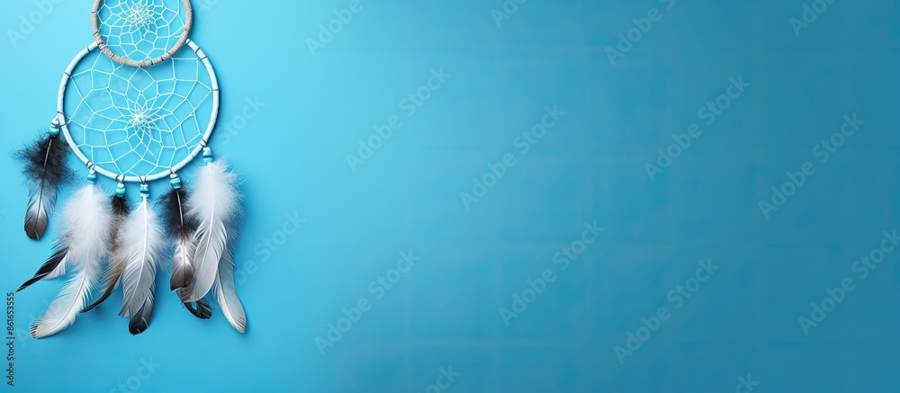 Aufkleber Top view of a dream catcher feature Asian attributes on a blue background with copy space image available.