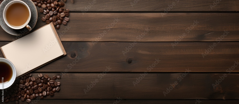 Poster items such as a notepad, pen, tea, and smartphone are arranged neatly on a wooden table with a blank