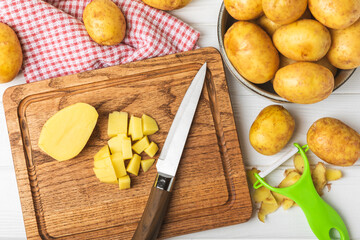 Young potatoes. Fresh potatoes  on a wooden background.Harvesting collection. organic, freshly dug potatoes. Agricultural background. Vegan. Vegetables.Place for text.Copy space