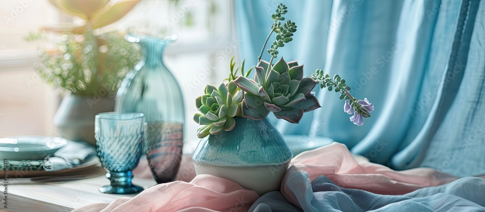 Poster table decoration. succulents in a vase on the table with blue and pink fabrics,with plates and glasses. with copy space image. Place for adding text or design