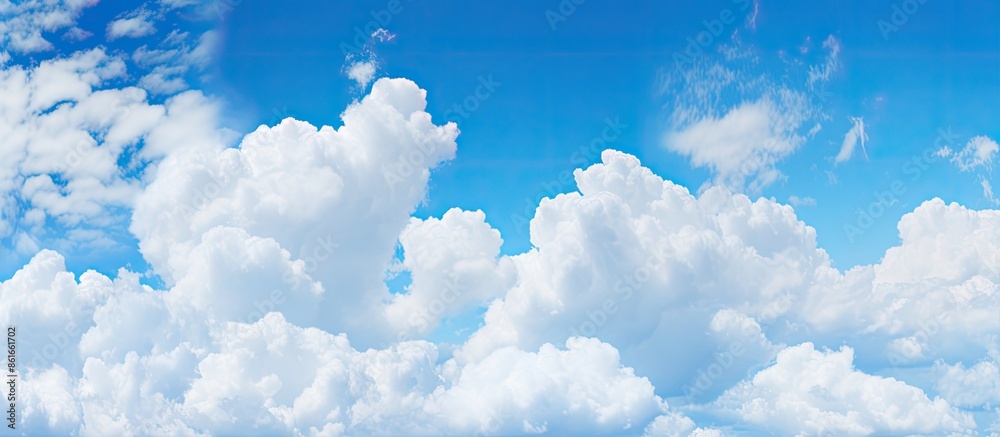 Aufkleber panoramic view of a blue sky with fluffy white clouds, perfect as a background for copy space image.