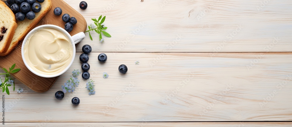 Fototapete Tasty toasts with butter, blueberries, and coffee displayed on a gray wooden surface in a flat lay style. Ideal for adding any text in the image. with copy space image