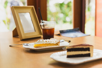 Fresh lemon meringue pie on wooden table in cafe.