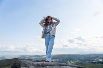 Obraz premium Happy Woman With Long Red Hair Posing on Mountain Top