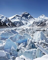 Majestic View of Mount Everest Surrounded by Snow and Ice, Clear Blue Sky in Broad Daylight