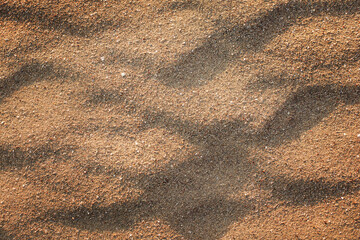 Background scattered golden sand lies in waves