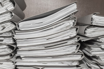 Paper documents stacked in archive. folders with documents on the shelves of archive room. Office...