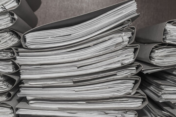 Paper documents stacked in archive. folders with documents on the shelves of archive room. Office...