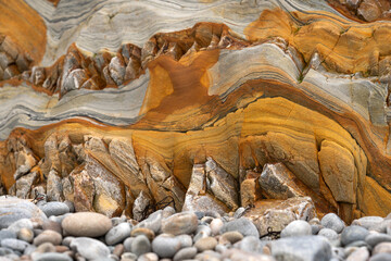 Natural rock texture of a colorful rock formations in silence beach (playa del Silencio) in Asturias, north of Spain.