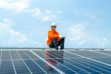 engineer man inspects construction of solar cell panel or photovoltaic cell by electronic device. Industrial Renewable energy of green power. factory worker working on tower roof.