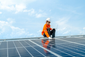 engineer man inspects construction of solar cell panel or photovoltaic cell by electronic device. Industrial Renewable energy of green power. factory worker working on tower roof.