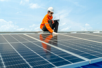 engineer man inspects construction of solar cell panel or photovoltaic cell by electronic device. Industrial Renewable energy of green power. factory worker working on tower roof.