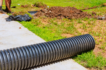 Installation of plastic black pipes for flow of rainwater to main collector