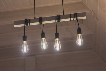 Modern loft lump on kitchen, new decor for interior in house. An incandescent light bulb,...