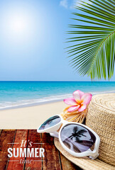 It's summer time banner with fashion sunglasses on jute hat on wooden table with space on tropical beach, summer outdoor day light, summer holiday season