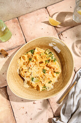 Authentic Shrimp and Spinach Pasta on Sunlit Beige Table Featuring Natural Shadows and Still Life Aesthetic