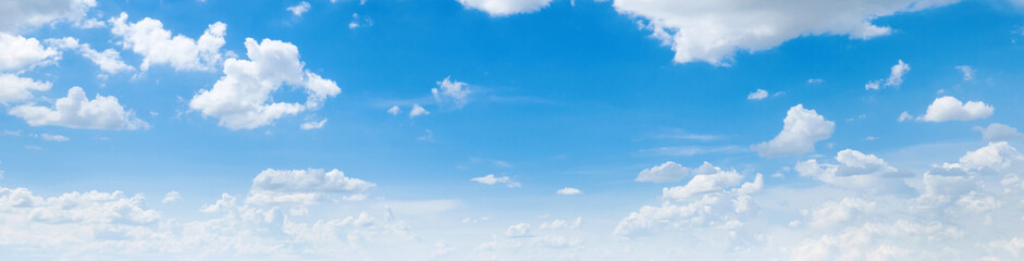 clear blue sky with a few clouds. The sky is very bright and the clouds are scattered throughout