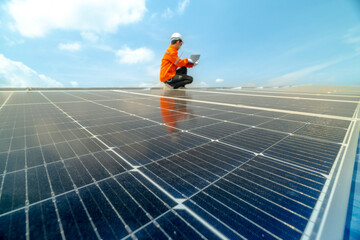 engineer man inspects construction of solar cell panel or photovoltaic cell by electronic device....