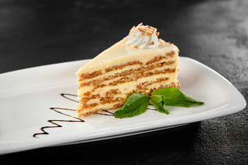 Slice of Carrot Cake with Cream Frosting on White Plate