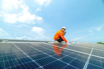 engineer man inspects construction of solar cell panel or photovoltaic cell by electronic device. Industrial Renewable energy of green power. factory worker working on tower roof.