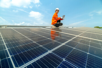 engineer man inspects construction of solar cell panel or photovoltaic cell by electronic device. Industrial Renewable energy of green power. factory worker working on tower roof.