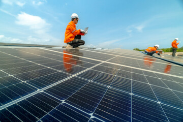 engineer man inspects construction of solar cell panel or photovoltaic cell by electronic device....