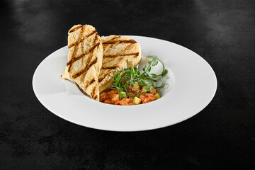 Salmon Tartare with Avocado and Grilled Ciabatta on Elegant White Plate