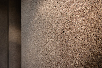 Brown decorative mosaic plaster on the corridor wall.
